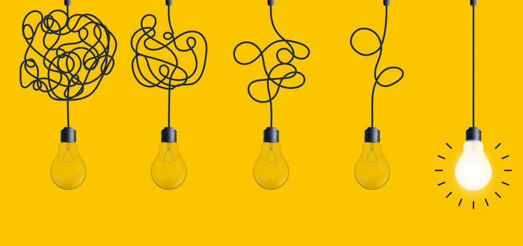 Hanging light bulbs on yellow background