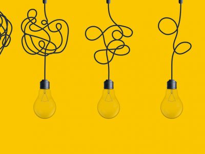 Hanging light bulbs on yellow background