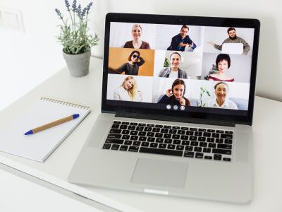 Man Working From Home Having Online Group Videoconference On Laptop